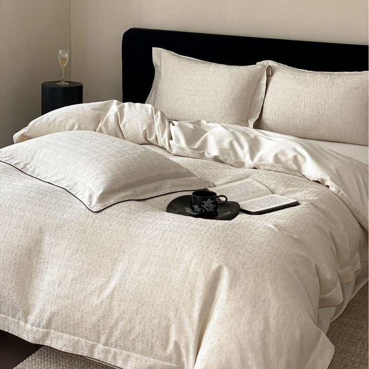 Finely woven cotton percale bedding set with subtle jacquard structure and contrast piping