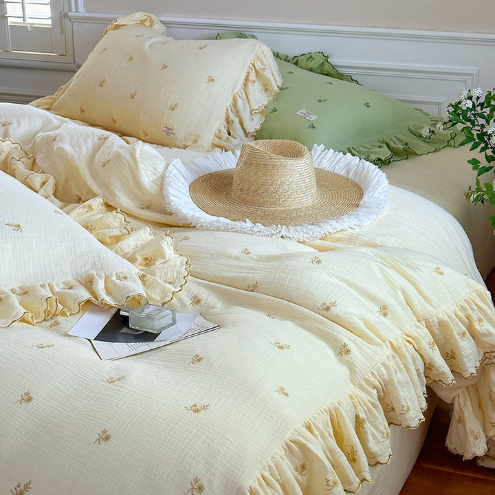 Vintage-inspired bedding set with ruffles and delicate floral embroidery