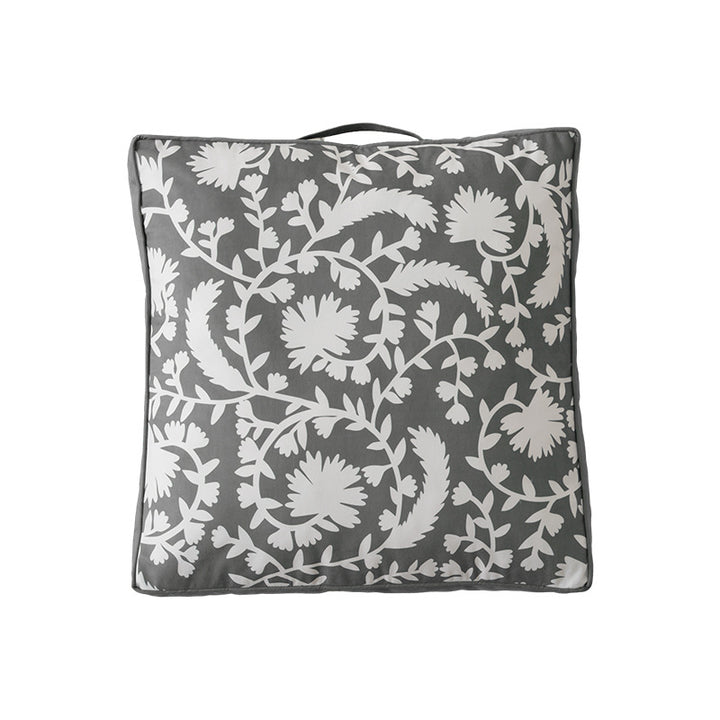 Padded floor cushion with quilted tufting, floral motif and carrying handle