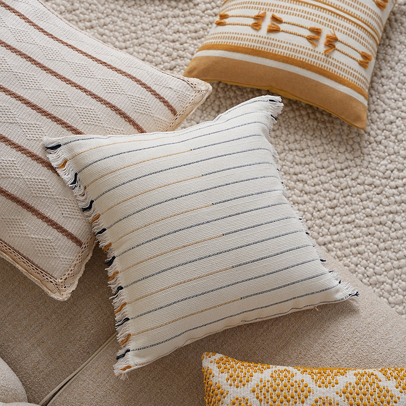 Structured square decorative pillow with crocheted trim and striped knit texture
