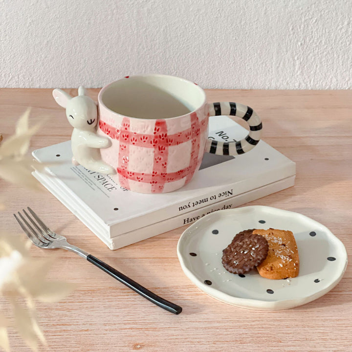 Playful ceramic cup set with koala relief handle and matching saucer