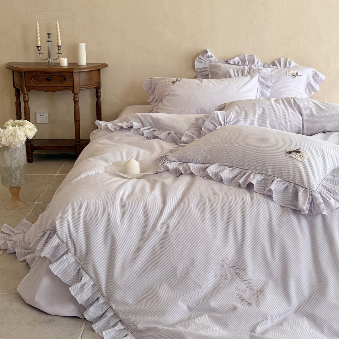 Ruffled bed linen set with fine striped texture and decorative frill