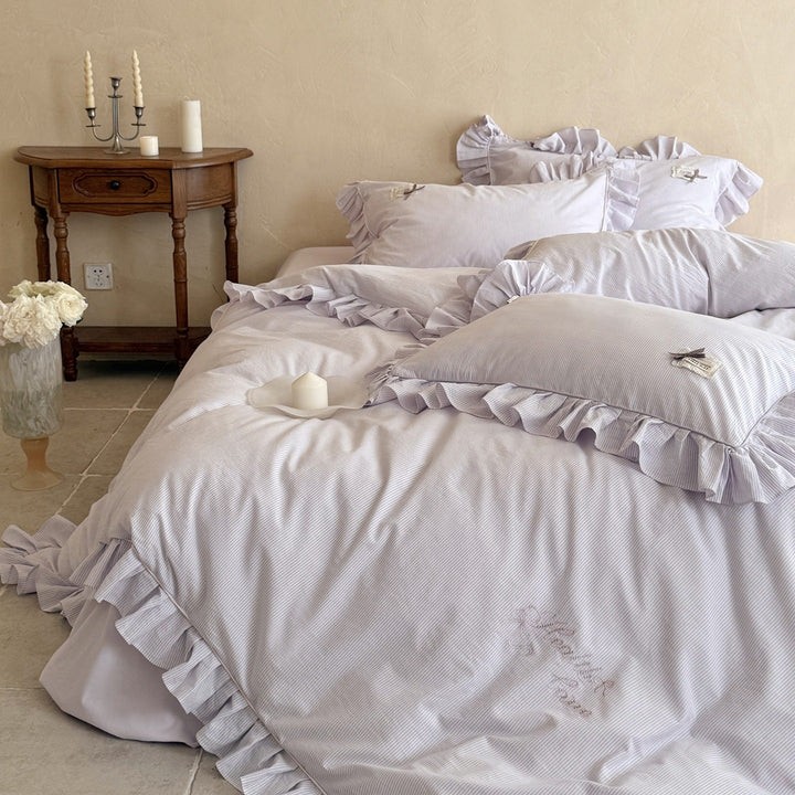 Ruffled bed linen set with fine striped texture and decorative frill
