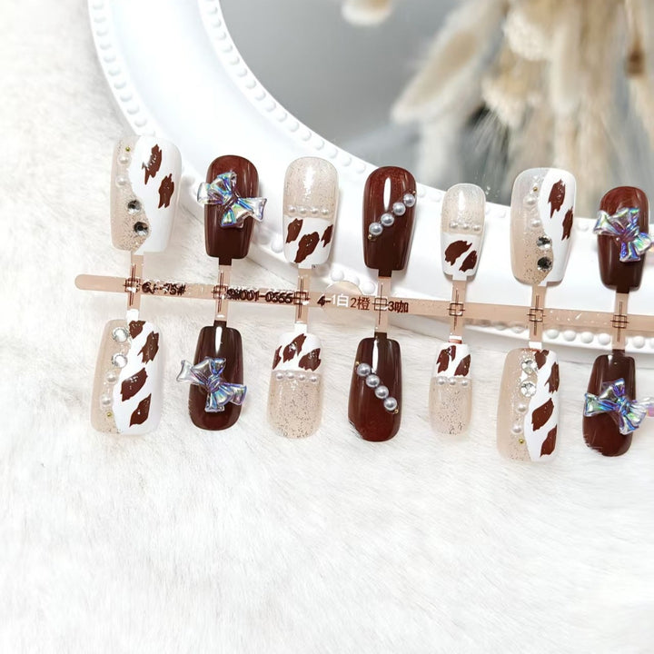 Artificial nails with sparkling rhinestone and bow accents Kalsten