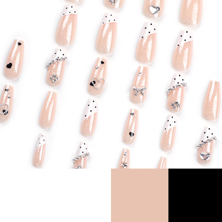 Artful nail extensions with elegant rhinestone and heart designs Kalsten