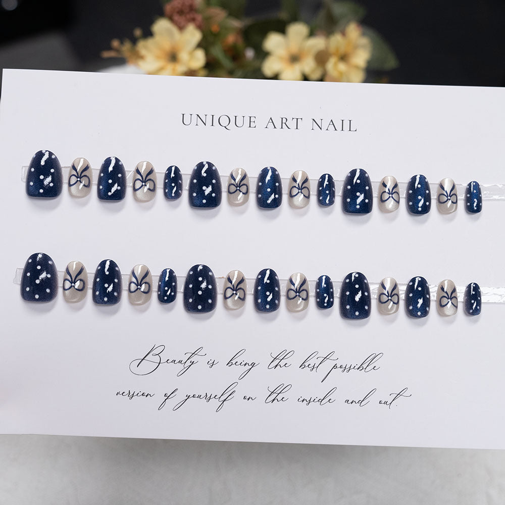 Decorative Nail Art with Bow and Polka Dot Design