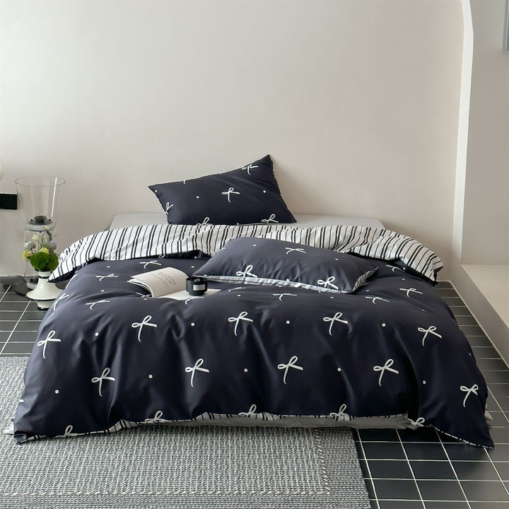 Modern cotton bedding set with minimal bow print and striped reversible side