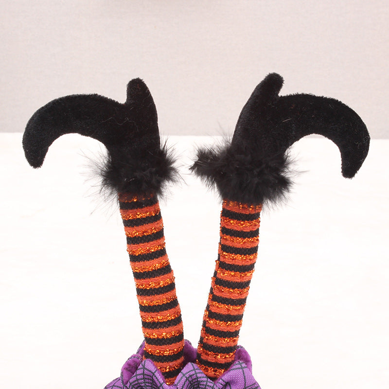 Skurrile Halloween table figure with standing witch legs and spider web sack