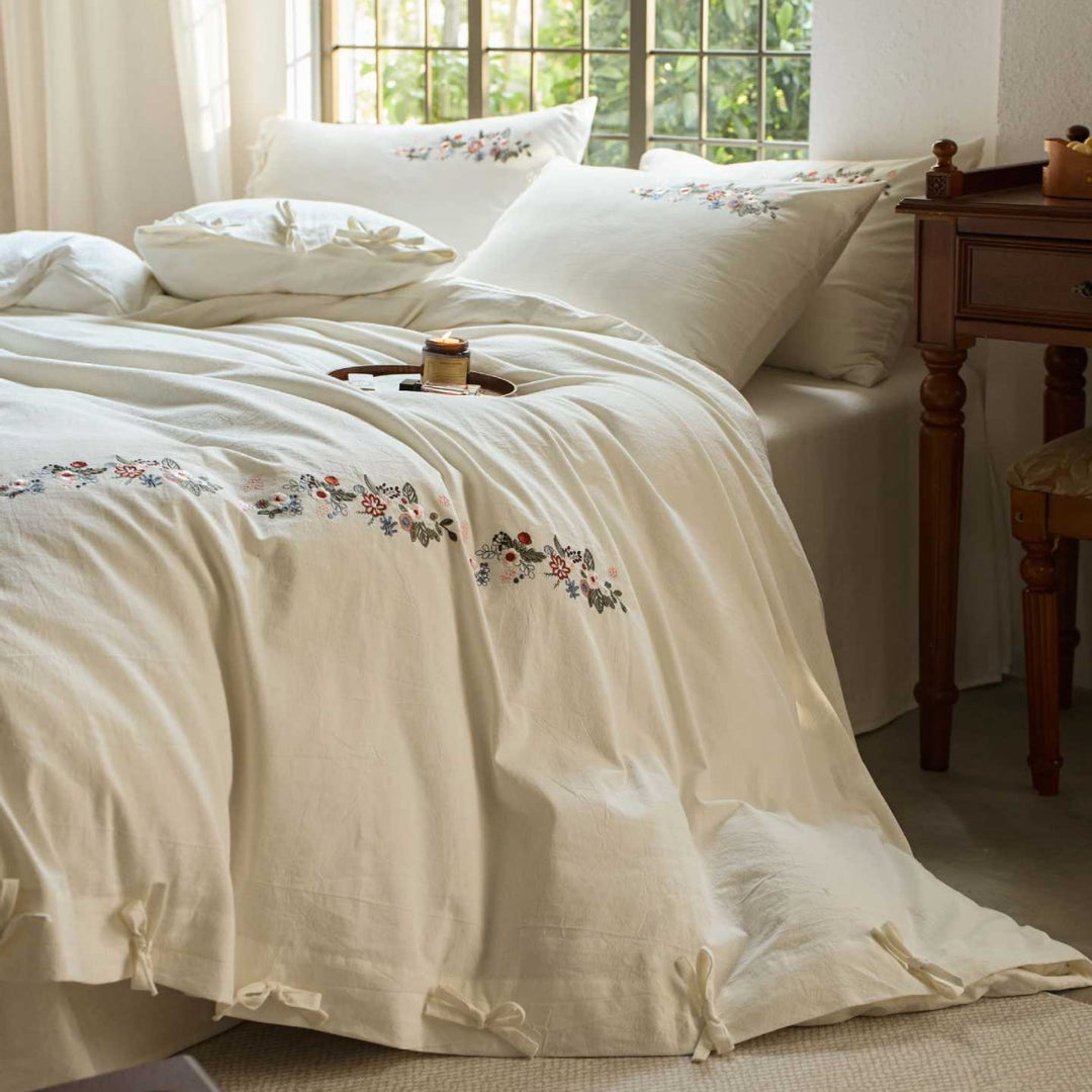 Embroidered cotton bedding set with floral border design and extra-soft percale quality