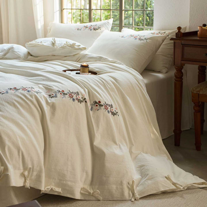 Embroidered cotton bedding set with floral border design and extra-soft percale quality