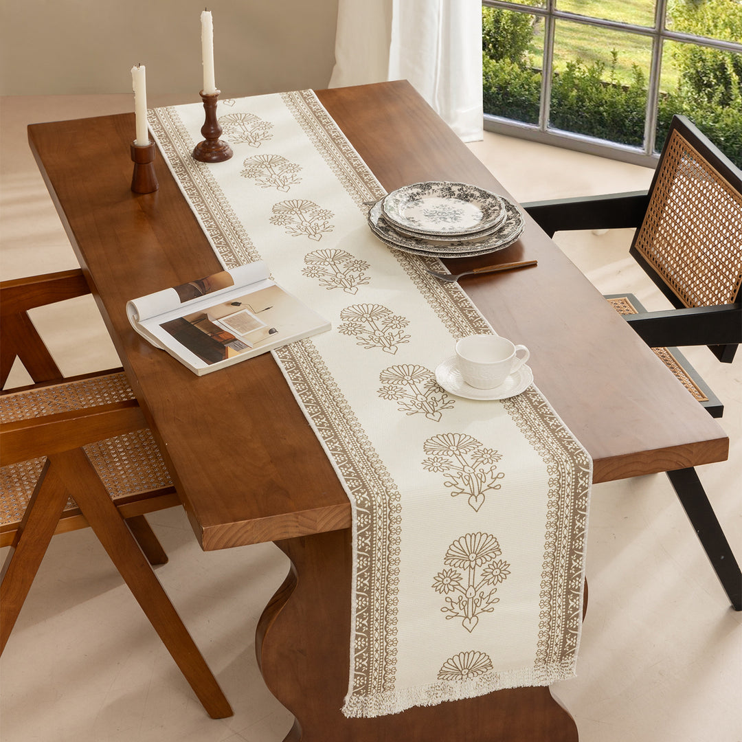 Table runner made of woven cotton blend with floral border