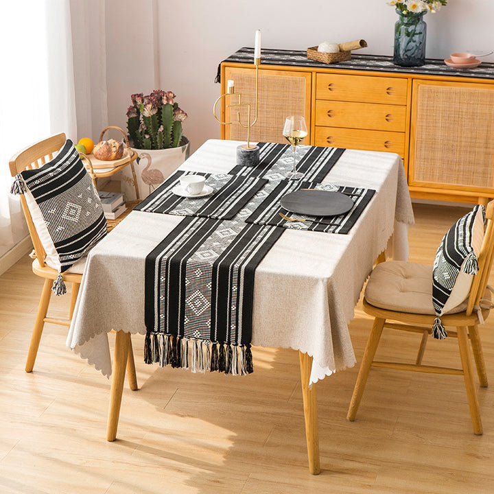 Handwoven table runner made of cotton blend with geometric weave pattern and fringe trim