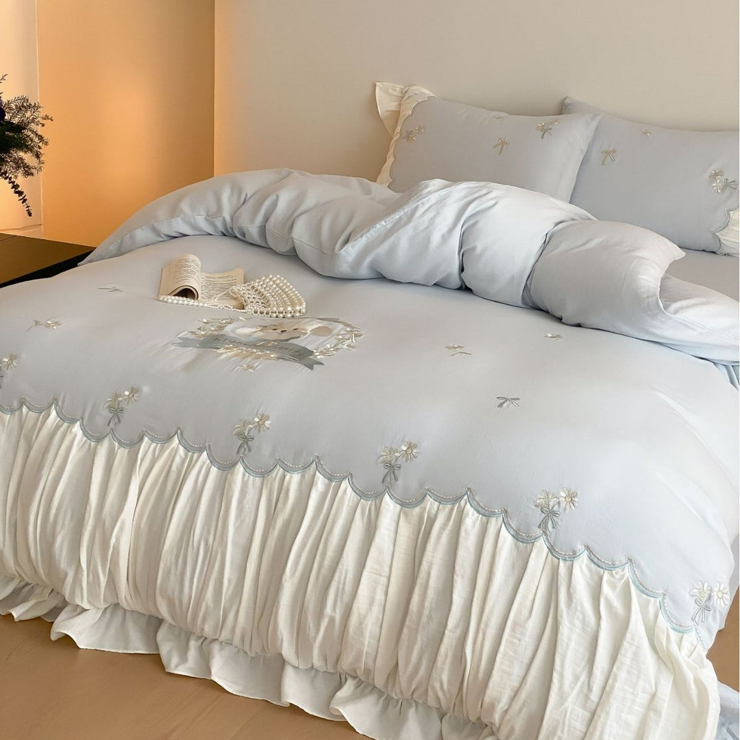 Playful cotton satin bedding set with ruffled bed skirt, floral embroidery, and frill cushion