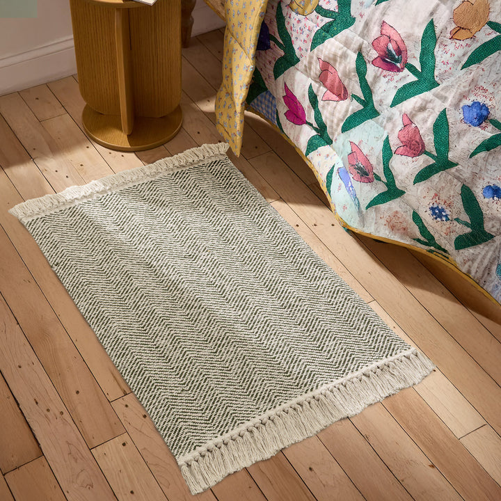 Handwoven runner rug with chevron weave and long fringes