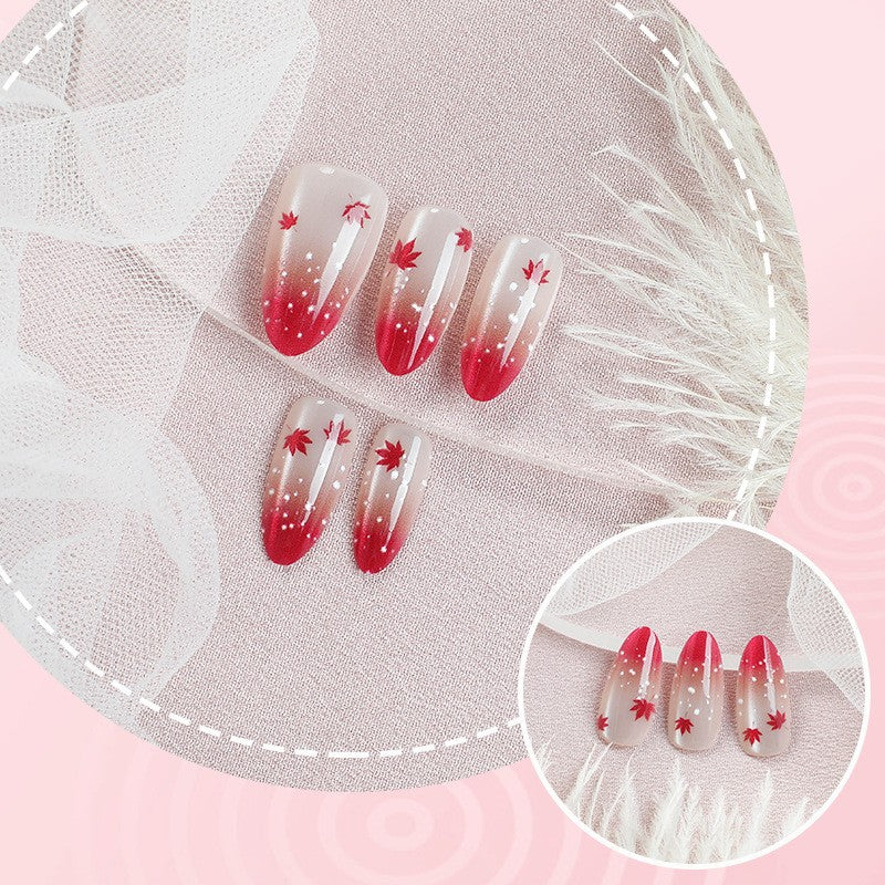 Art nail set with elegant red ombré look and delicate maple leaves Kalsten