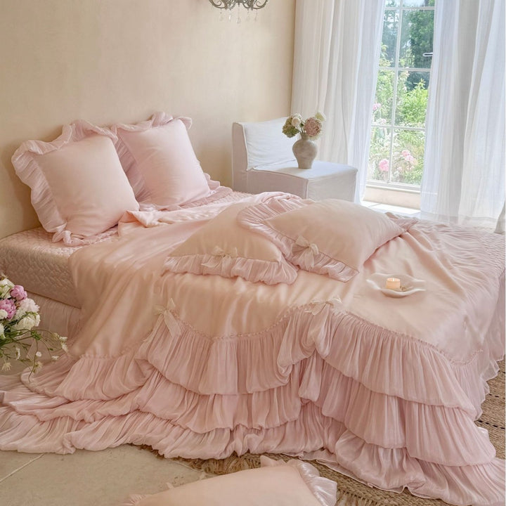 Romantic satin bedding and bedspread set with decorative ruffles and bows