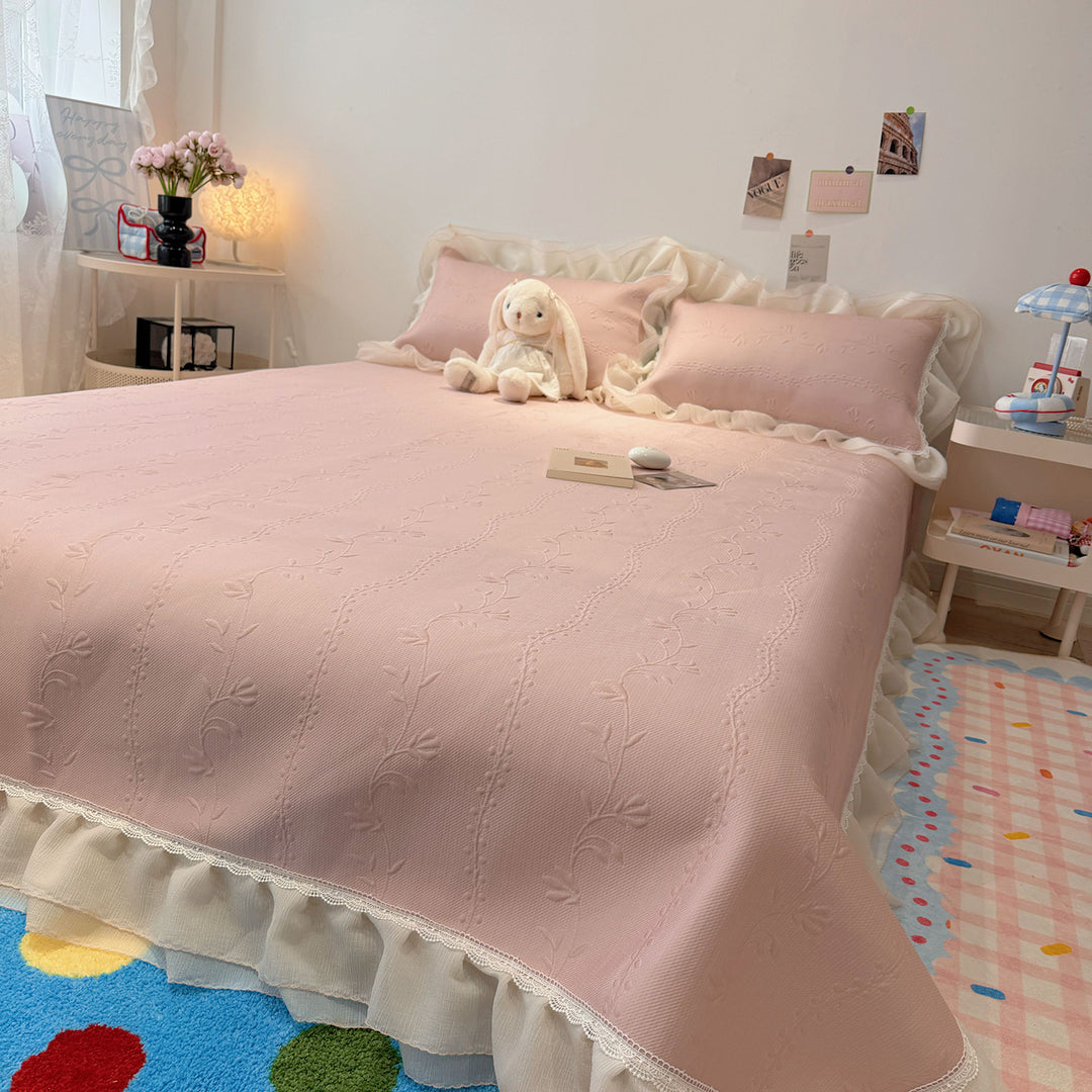 Quilted bedspread with ruffle and delicate floral quilting