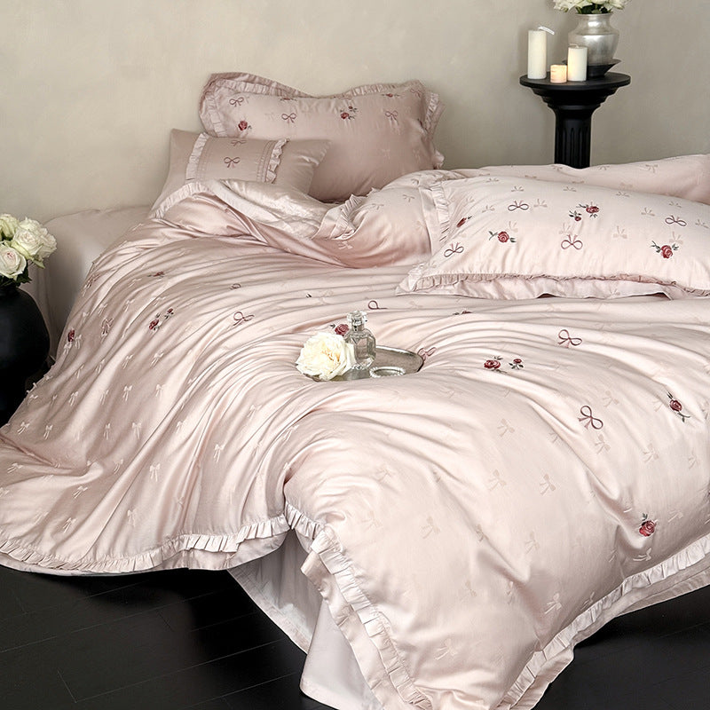 Luxurious satin bedding set with delicate floral embroidery and ruffles