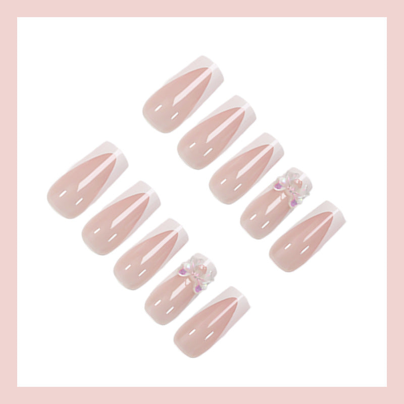 Artificial nail set with luxurious French tips and elegant jewelry embellishments Kalsten