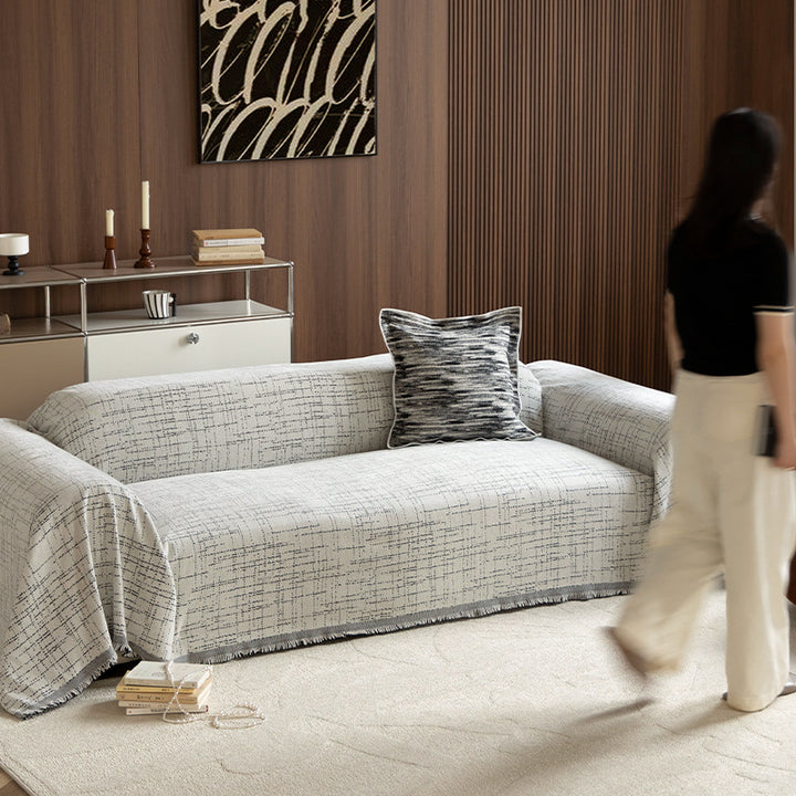 Universal three-seater protection cover made of woven cotton blend with fringes