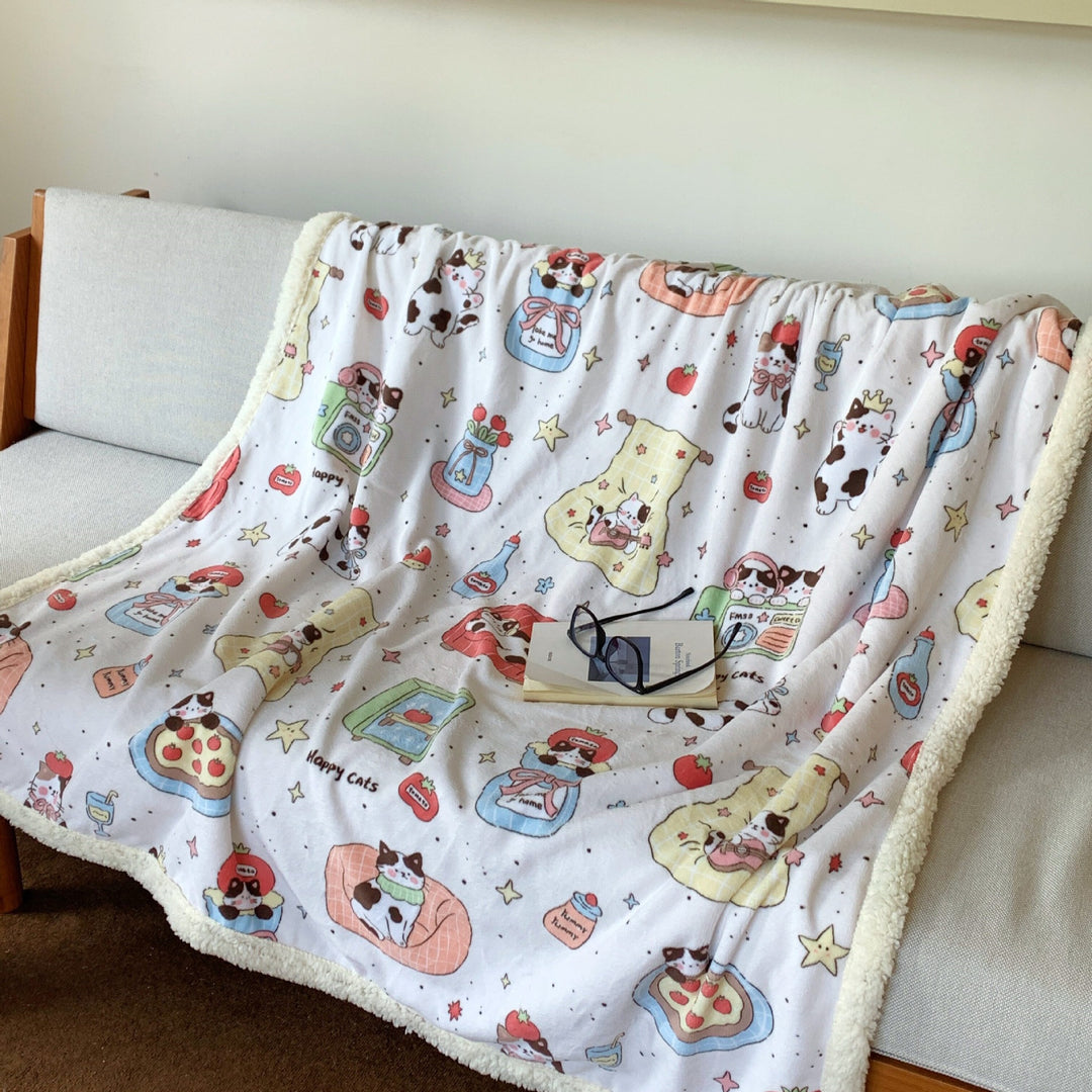 Reversible fleece blanket with cartoon cat design and teddy lining