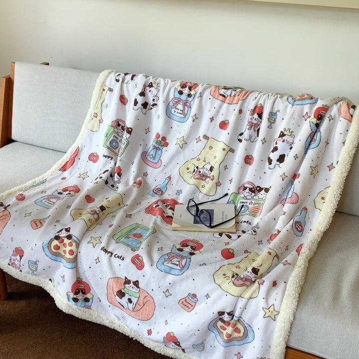 Reversible fleece blanket with cartoon cat design and teddy lining