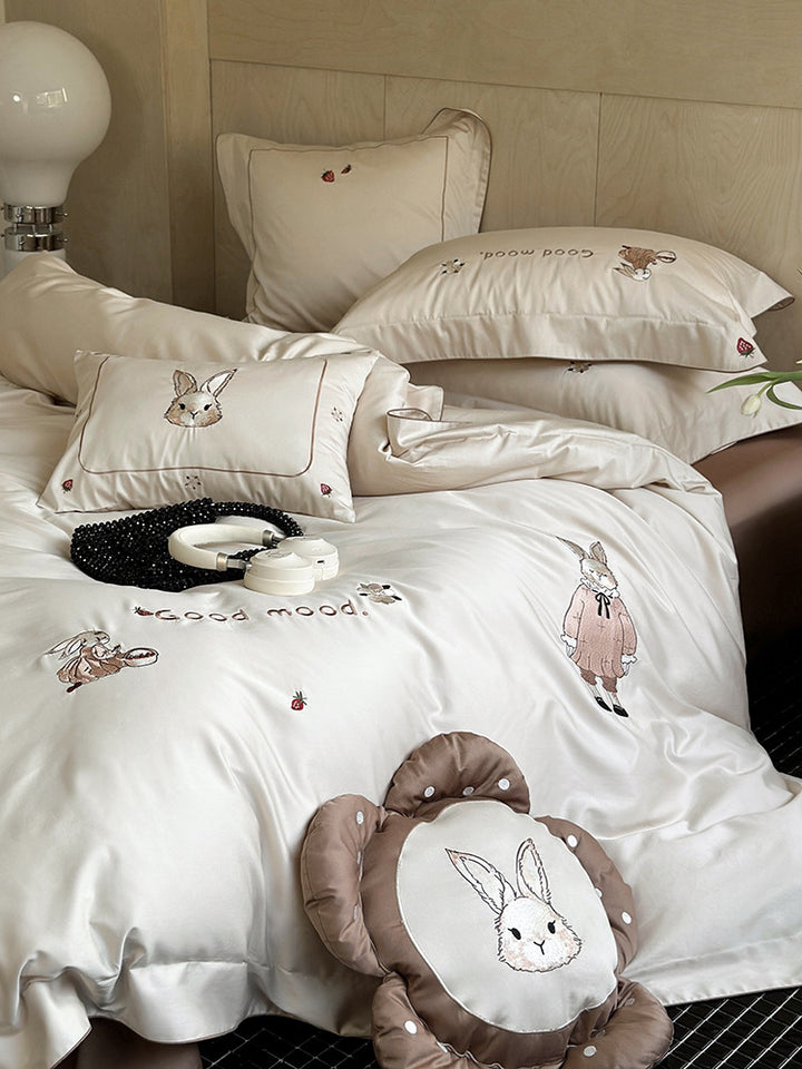 Fine cotton satin bedding set with elaborate bunny embroidery and piped edge