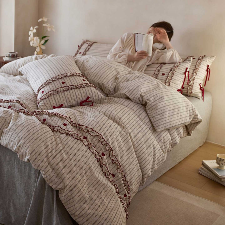 Striped bedding set with ruffles and heart applique