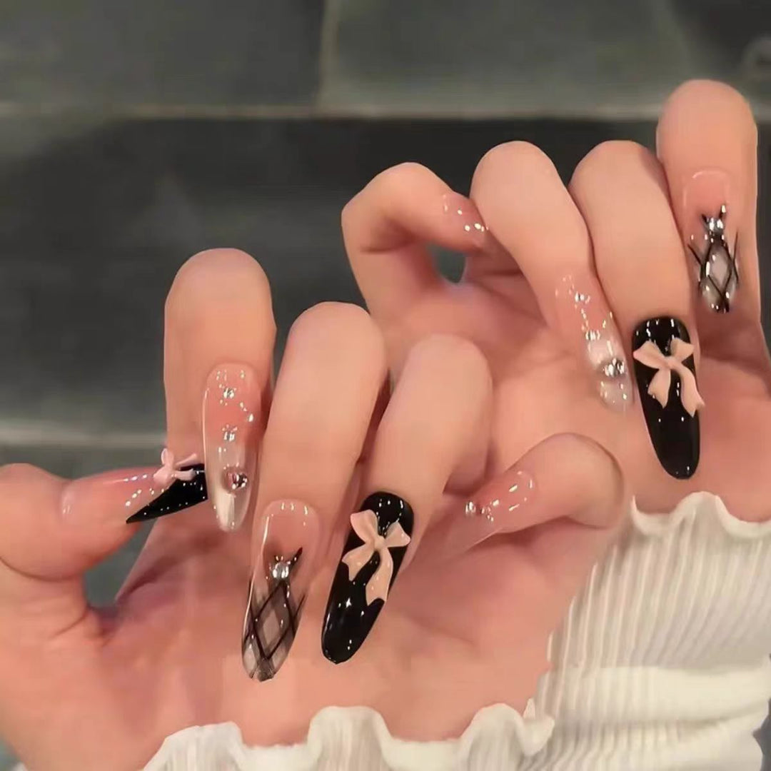 Artificial nails with playful bow and glitter accents Kalsten