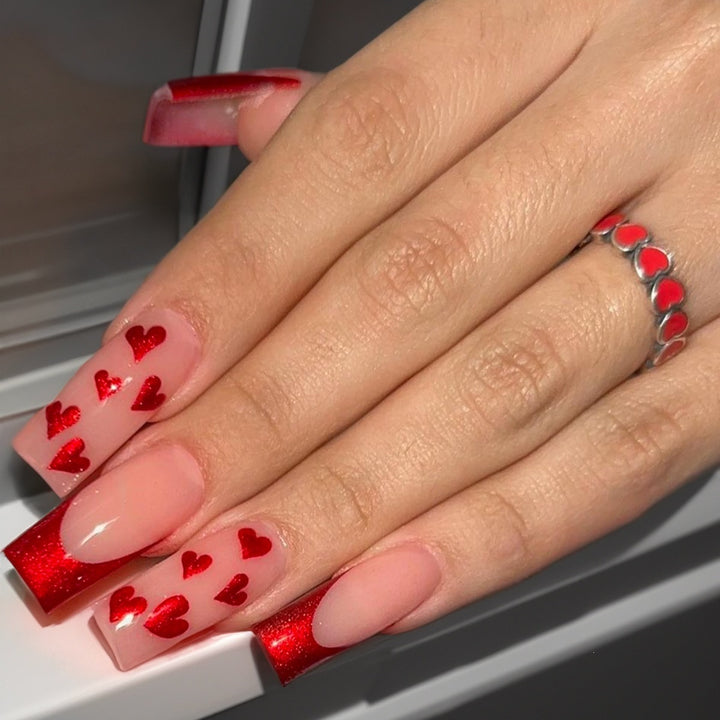 Acrylic nail set with glamorous heart designs and glitter accents Kalsten