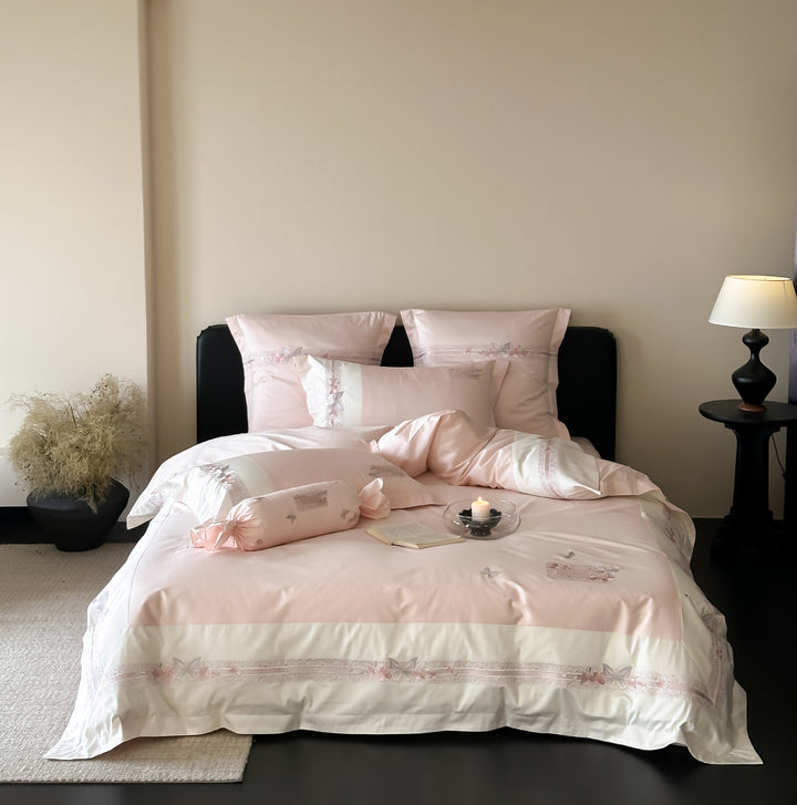 Luxurious cotton satin bed linen set with appliquéd flowers and decorative rolled hem