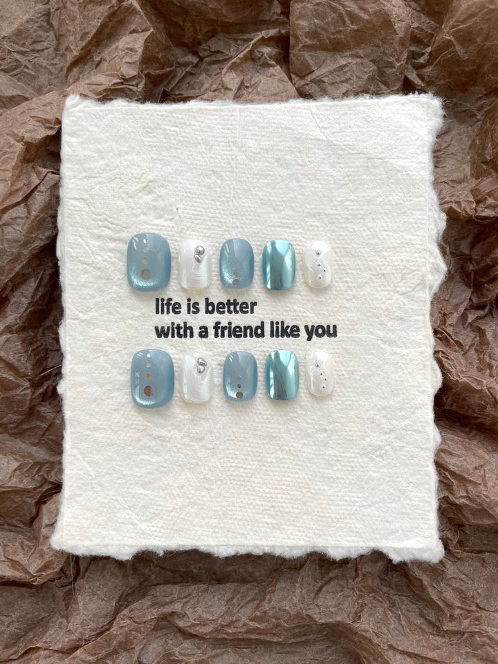 Artistic Press-On Nail Art Set with Unique Button and Ocean-Inspired Designs