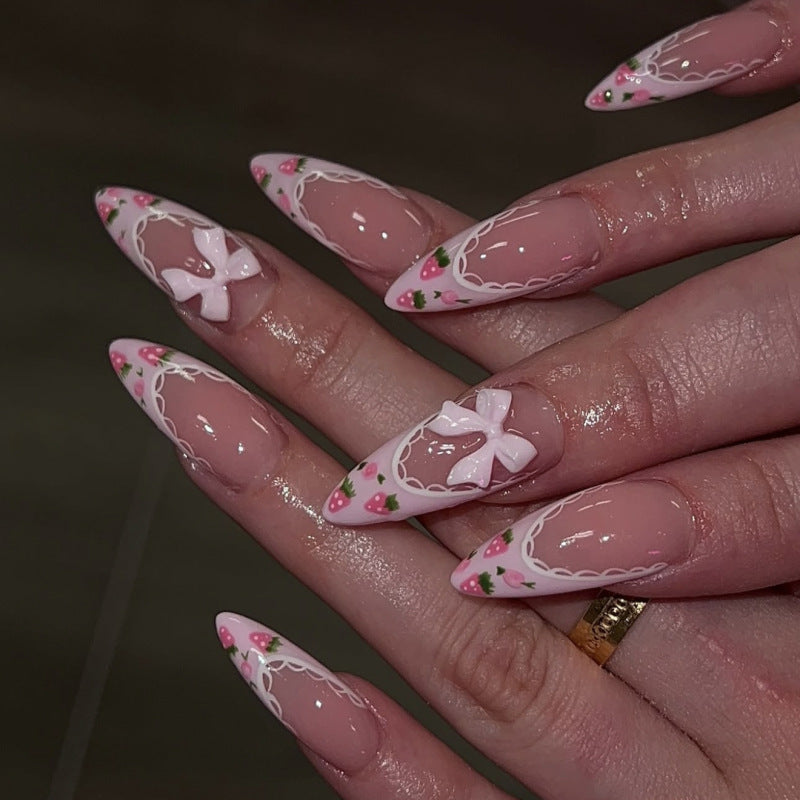 Artful stiletto nails with floral accents and bow embellishments Kalsten