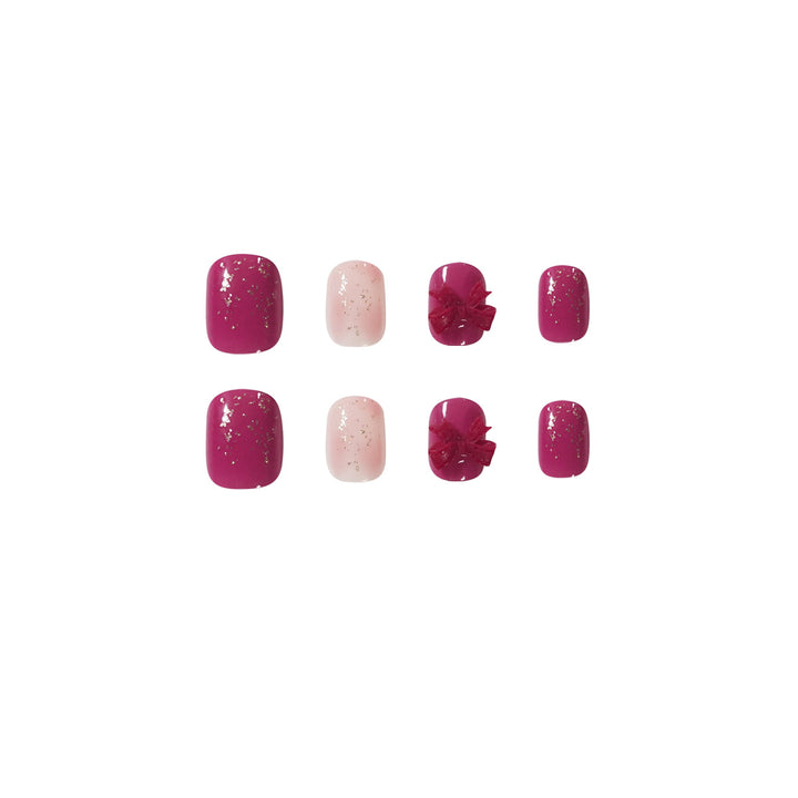 Artificial nail art with glitter embellishments and cute bow motif Kalsten