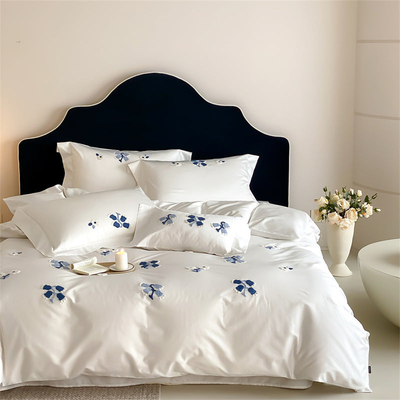 Embroidered cotton satin bedding set with subtle blue flower patterns