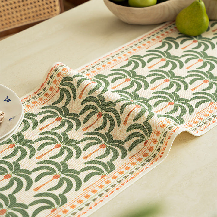 Woven table runner with floral embroidery and fringe trim