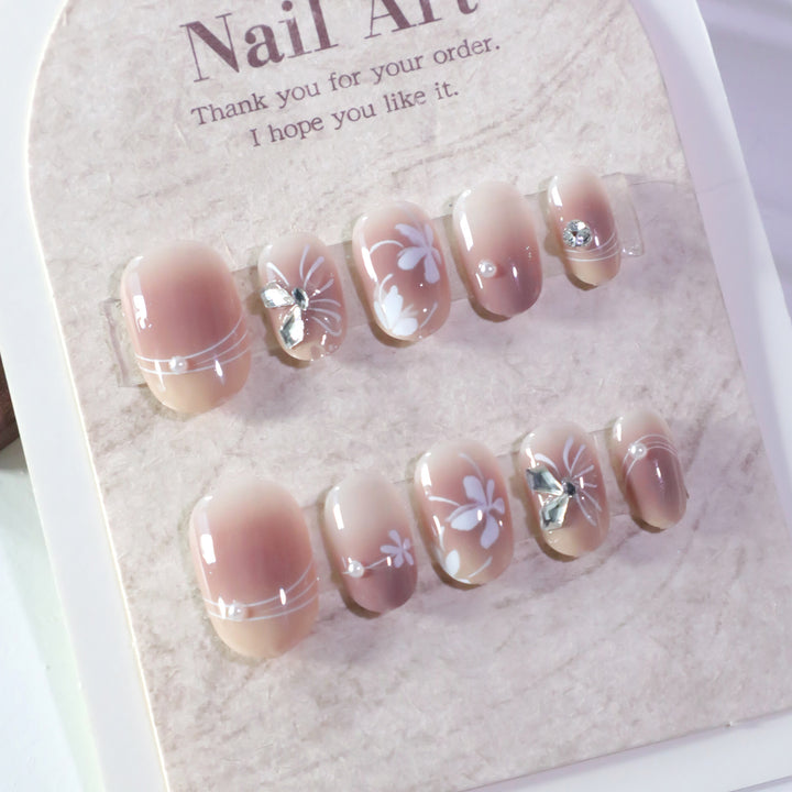 Artful nail design with floral pattern and glitter accents Kalsten