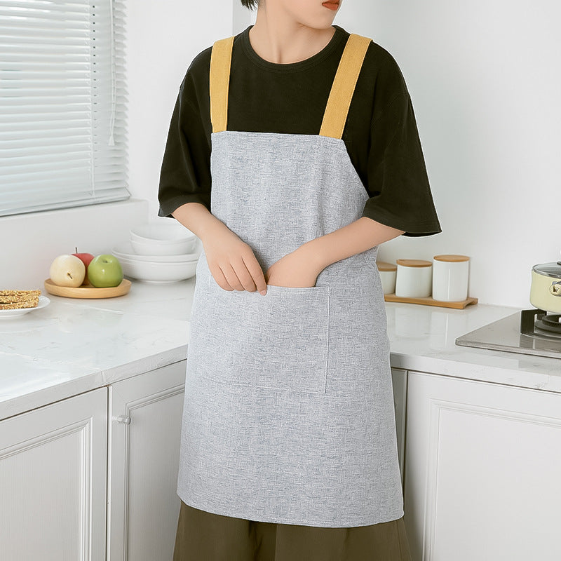 Apron with cross straps and large front pocket made of linen blend