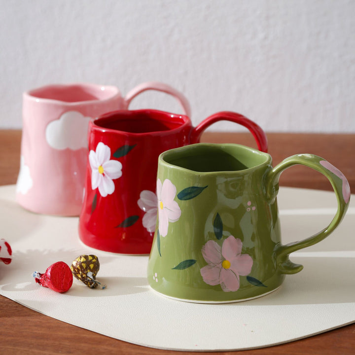 Hand-shaped ceramic mug with cloud relief and organic edge