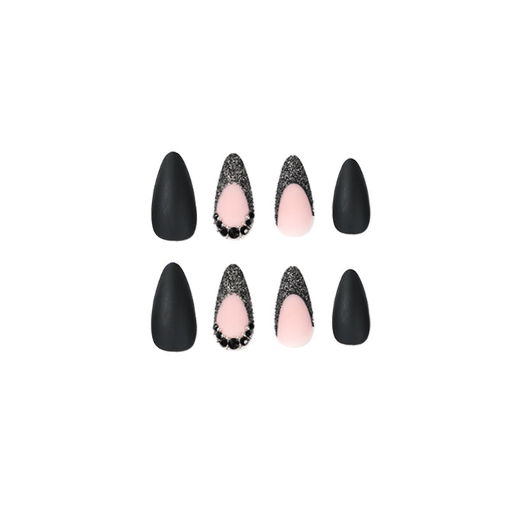 Artful stiletto nails with elegant black design and glitter accents Kalsten