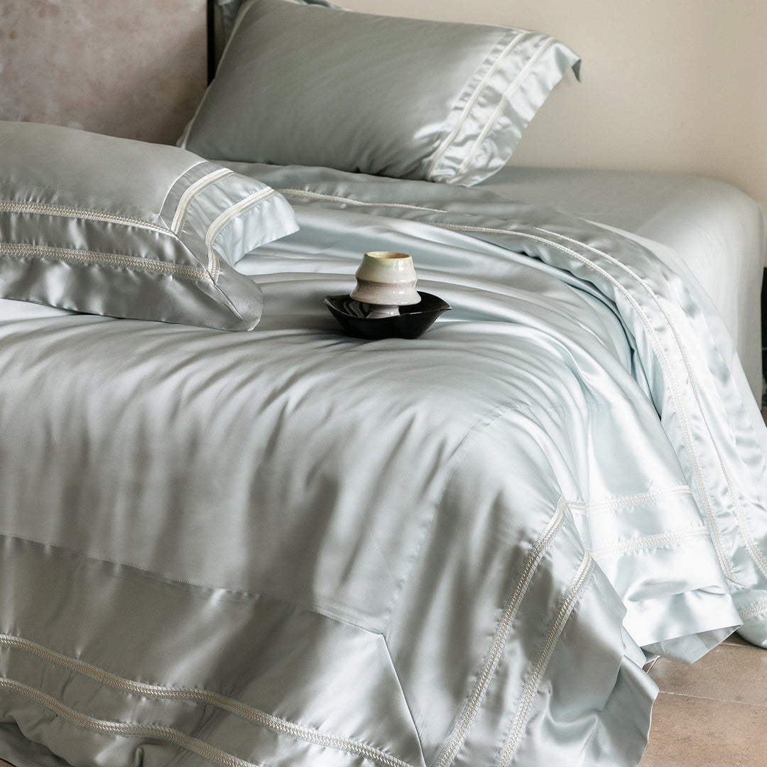 Luxurious satin bedding set with decorative borders and silky-smooth feel