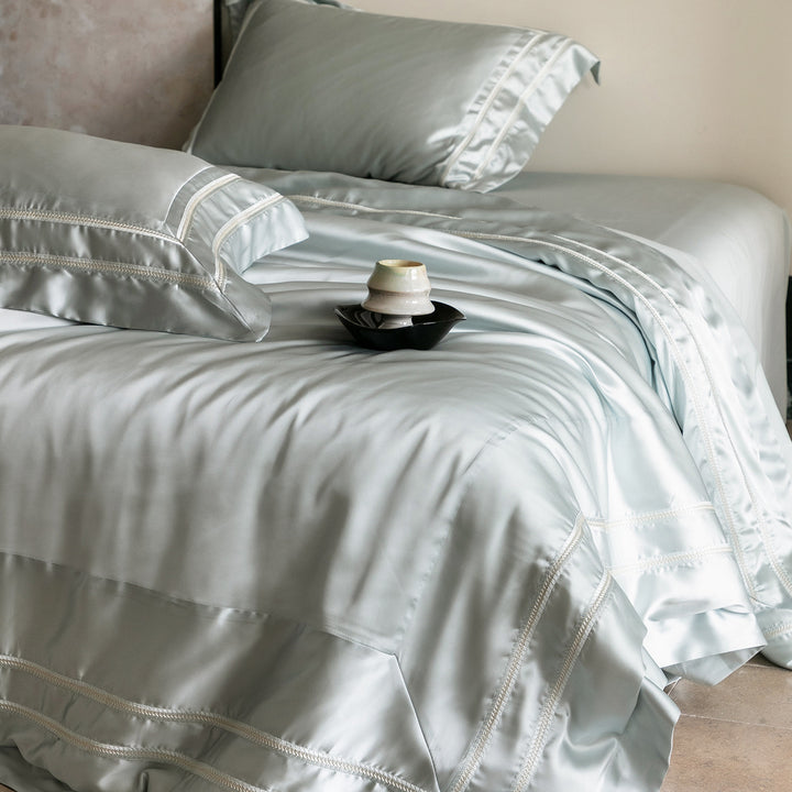 Luxurious satin bedding set with decorative borders and silky-smooth feel
