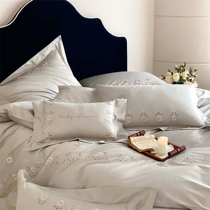 Satin bedding set with delicate flower embroidery and silk-soft touch