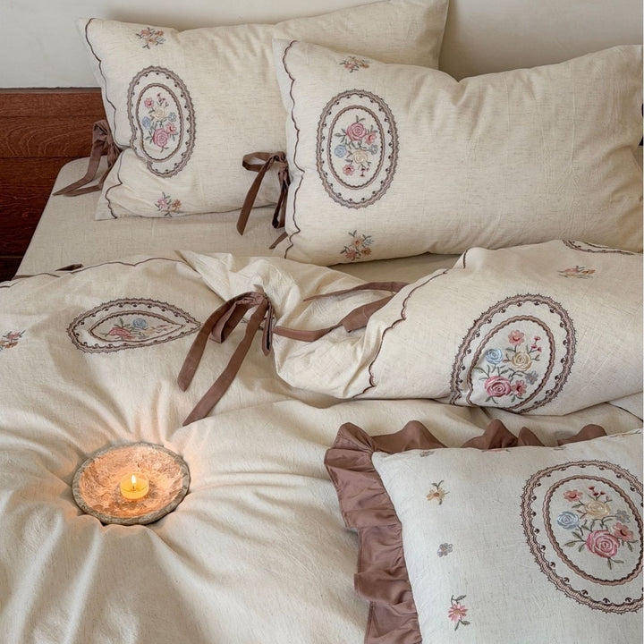 Romantic cotton-linen bedding set with embroidered flower medallions and ruffles