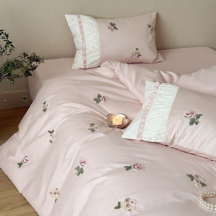 Luxurious cotton bedding set with delicate rose embroidery and ruffles