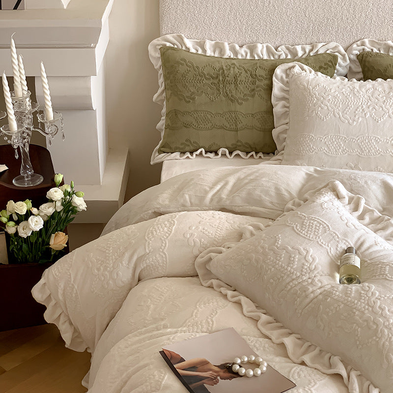 Quilted bedding set with ruffled hem and tone-on-tone embroidery