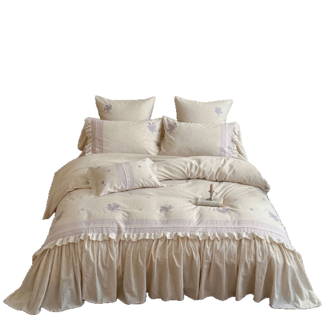 Vintage-inspired bedding set with ruffled bed skirt and delicate floral embroidery