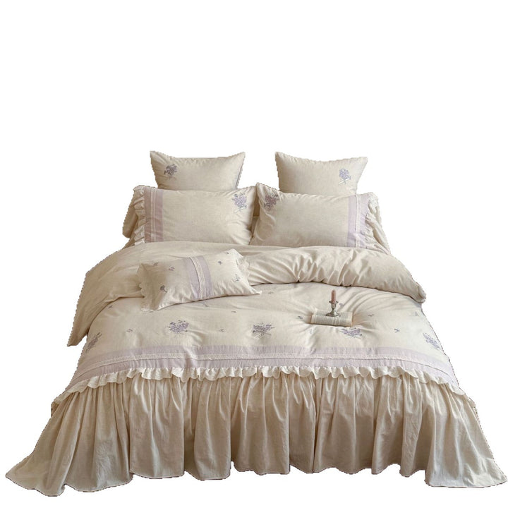 Vintage-inspired bedding set with ruffled bed skirt and delicate floral embroidery