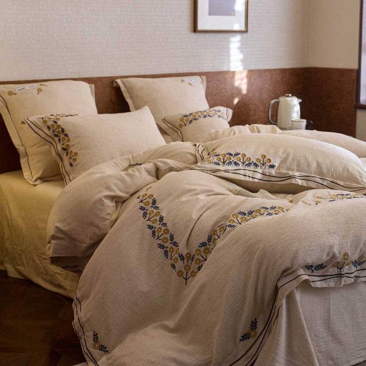 Bedding set with finely embroidered floral border design