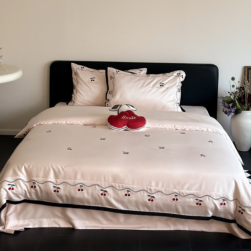 Noble satin bed linen set with cherry applique, decorative piping and frill